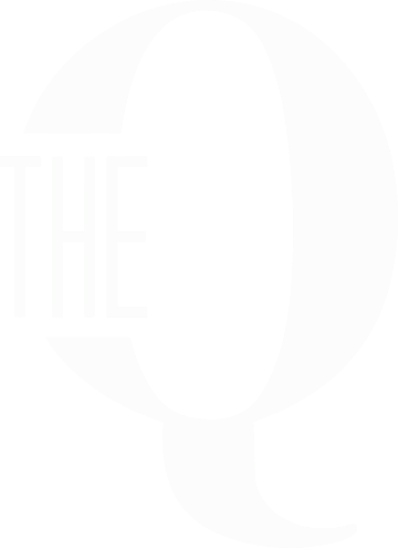 A black and white image of a large white letter Q with the word "THE" above it.